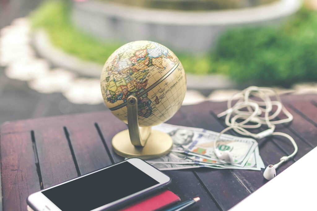 A globe money phone and earphones are placed on top of the table