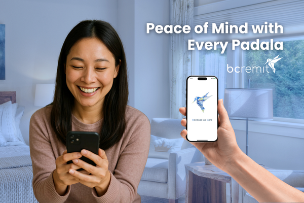 A smiling woman uses her phone while another hand displays the BCRemit app, showcasing a secure transaction—BCRemit is the best remittance app for Filipino migrants.